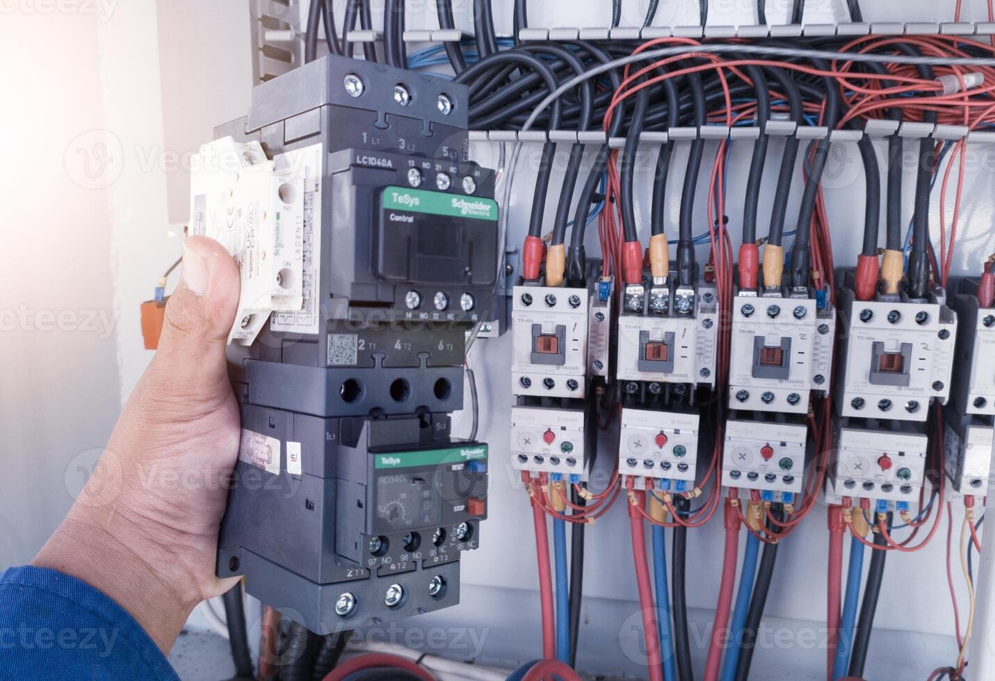 Replacement of the magnetic contactor set in the machine control panel, the concept of repairing electrical controls on machines by replacing parts. photo