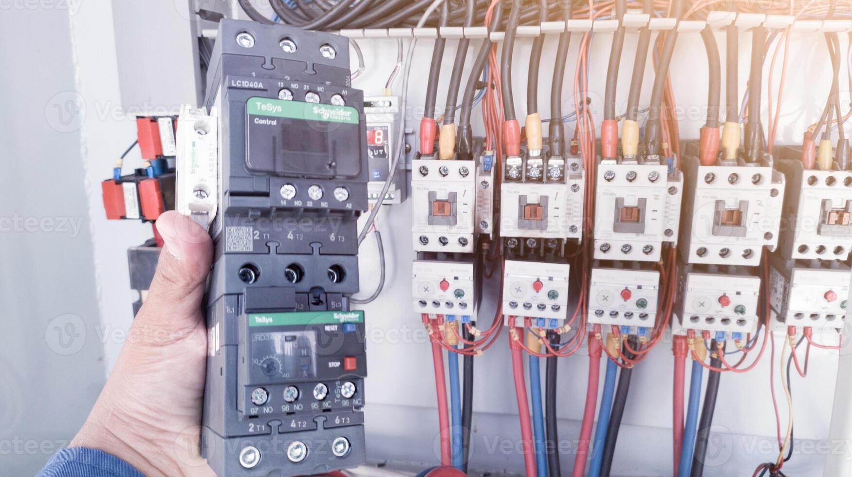 Replacement of the magnetic contactor set in the machine control panel, the concept of repairing electrical controls on machines by replacing parts. photo