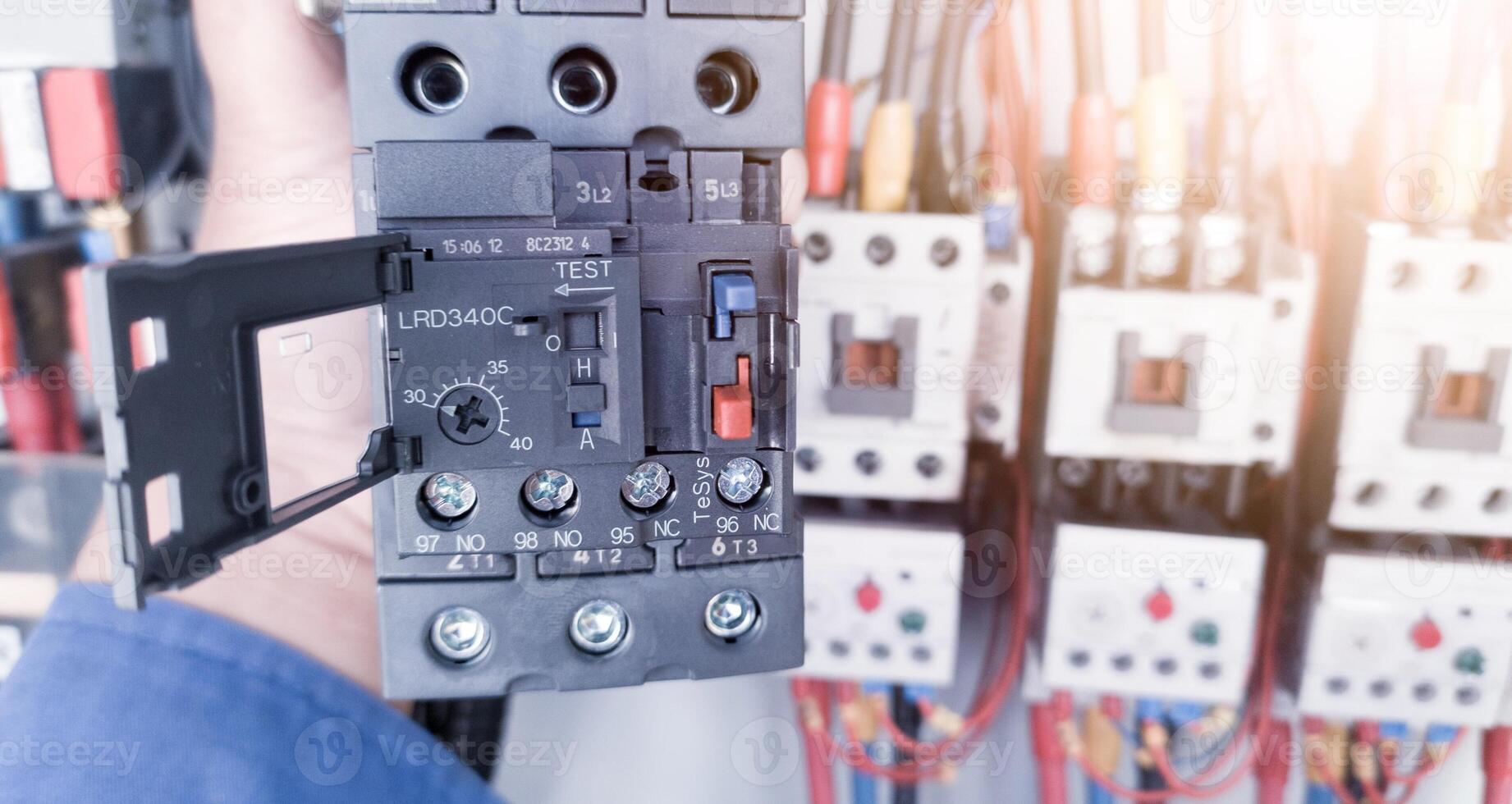 Replacement of the magnetic contactor set in the machine control panel, the concept of repairing electrical controls on machines by replacing parts. photo