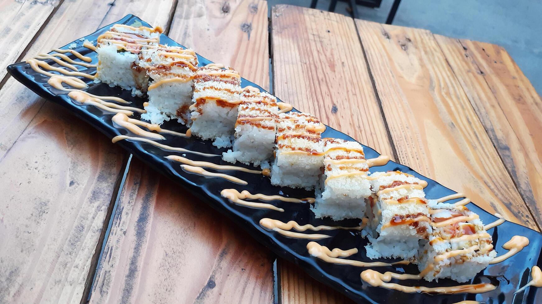 typical japanese food on a black plate photo