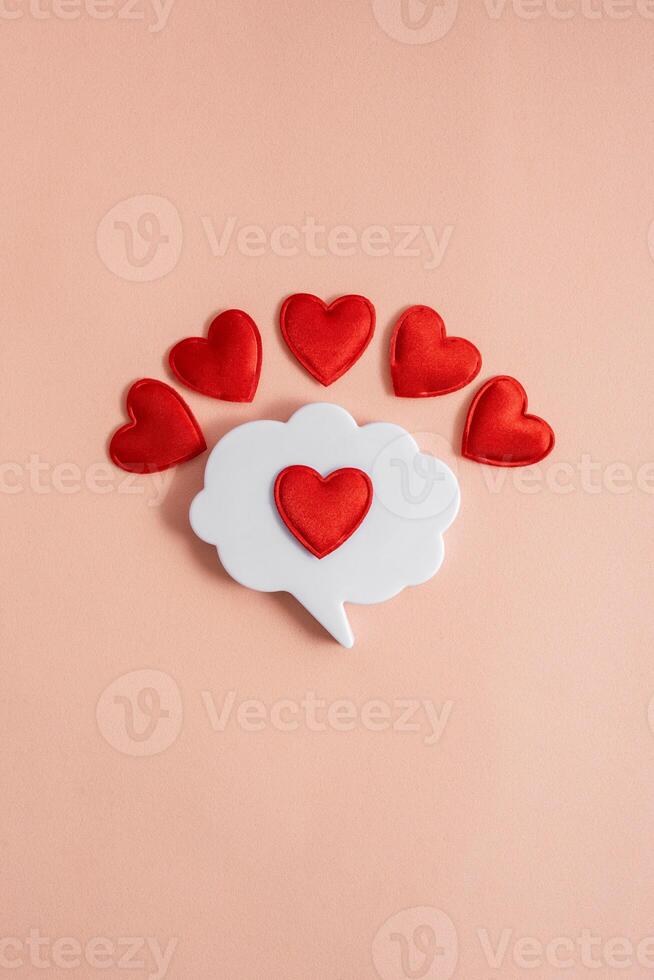 Chat icon with hearts on a light background. Online dating. Online love and acquaintance. Communication via chat. Modern love. Copy space. photo