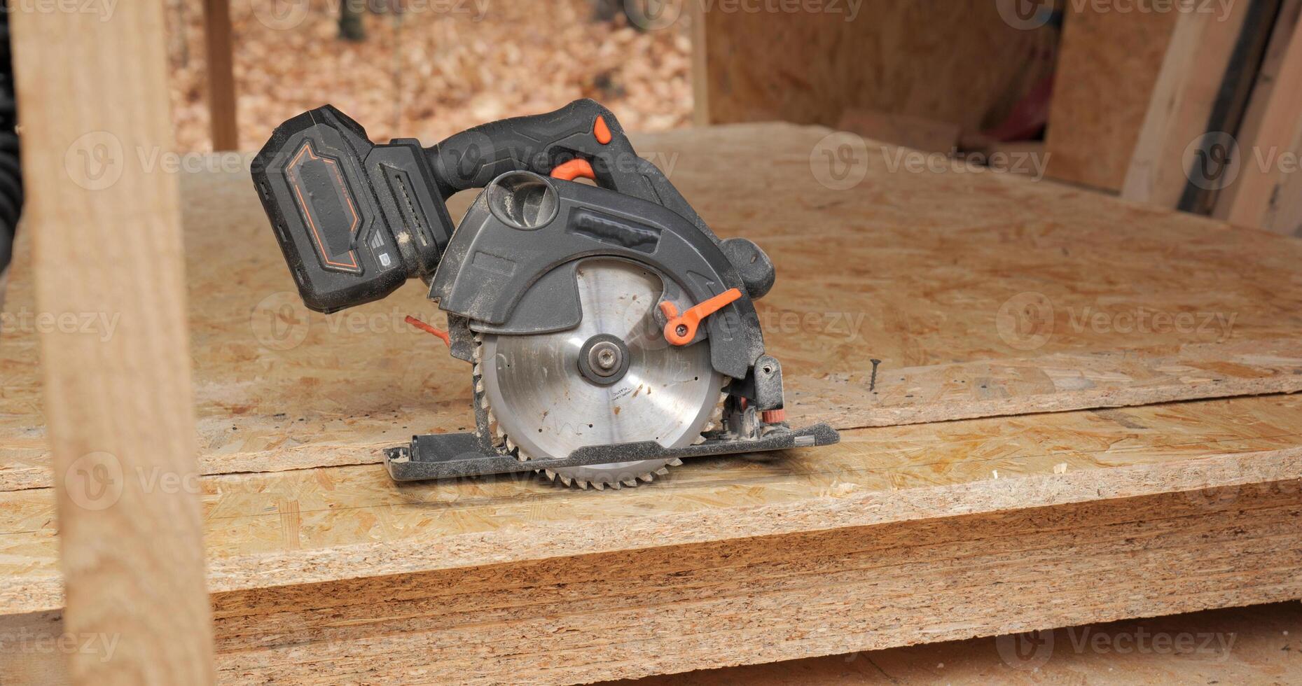 Close-up of a circular saw for cutting plywood. Construction of a new wooden house using frame technology. Carpentry and construction concept. photo