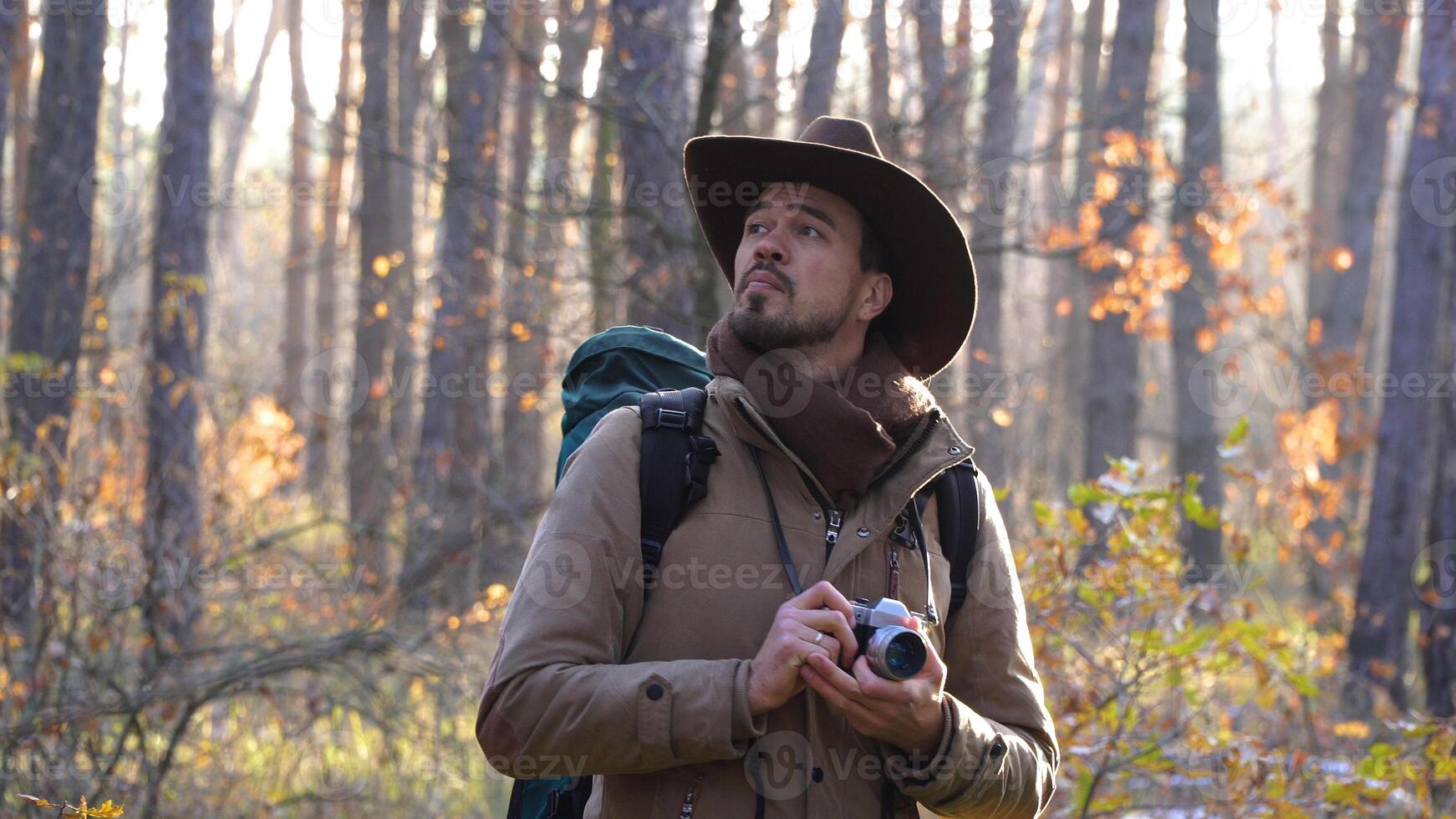 A tourist with a camera travels in the forest. Travel concept photo