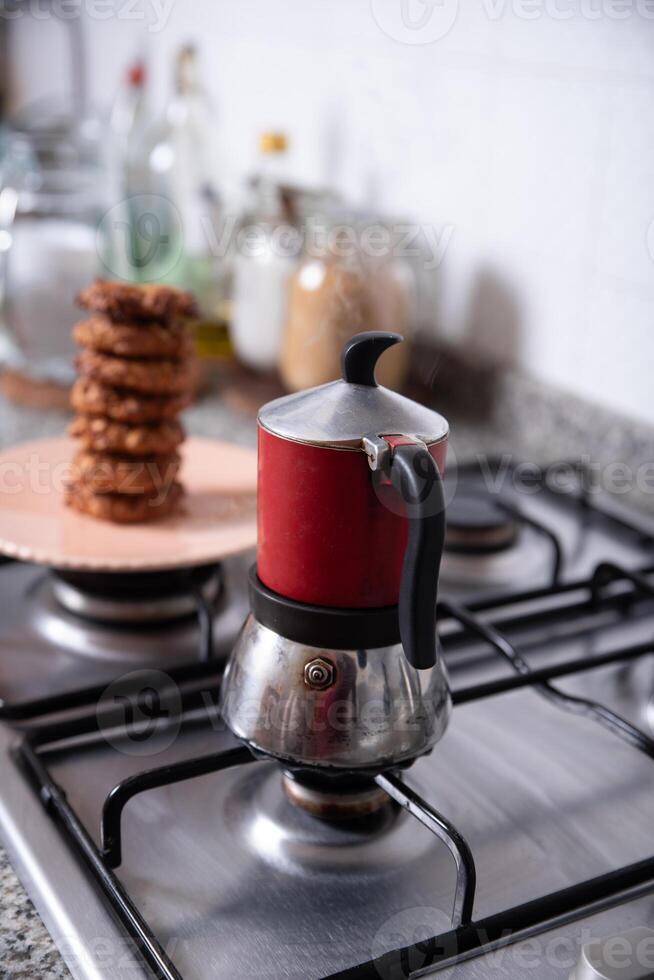 Freshly prepared cookies in the kitchen, served on a plate next to a coffee maker. photo