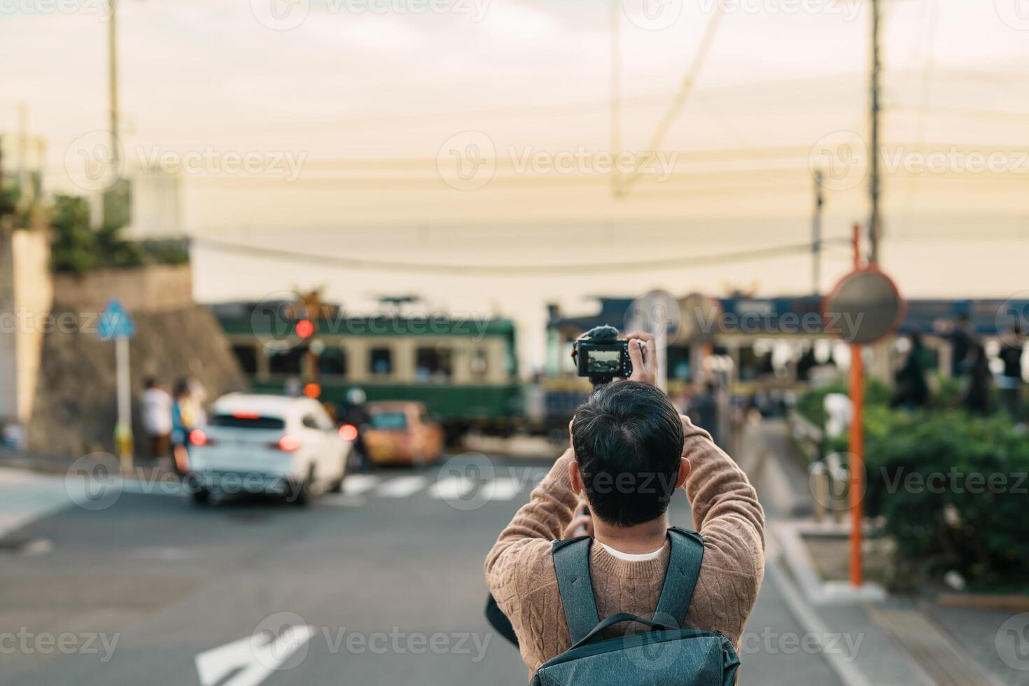 man tourist Visiting in Kamakura, Kanagawa, Japan. happy Traveler sightseeing Kamakurakokomae train station. Landmark and popular for tourists attraction near Tokyo. Travel and Vacation concept photo