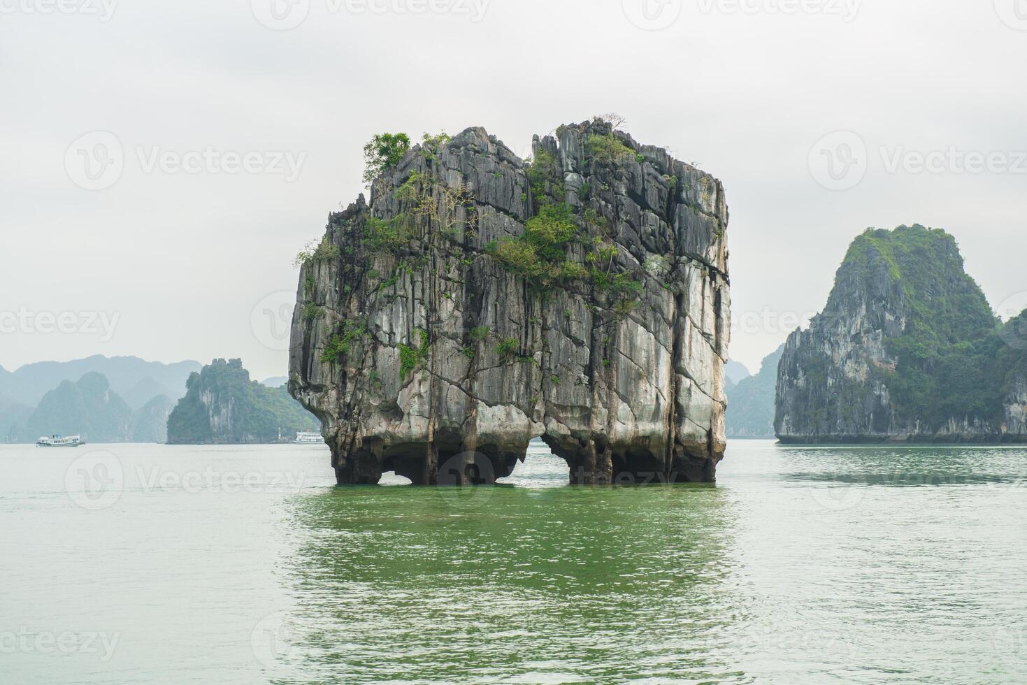 An iconic karst called 'Money island' because this karst is the picture symbol show on Vietnamese 200,000 dong banknotes. Halong Bay, Unesco world heritage site of Vietnam. photo
