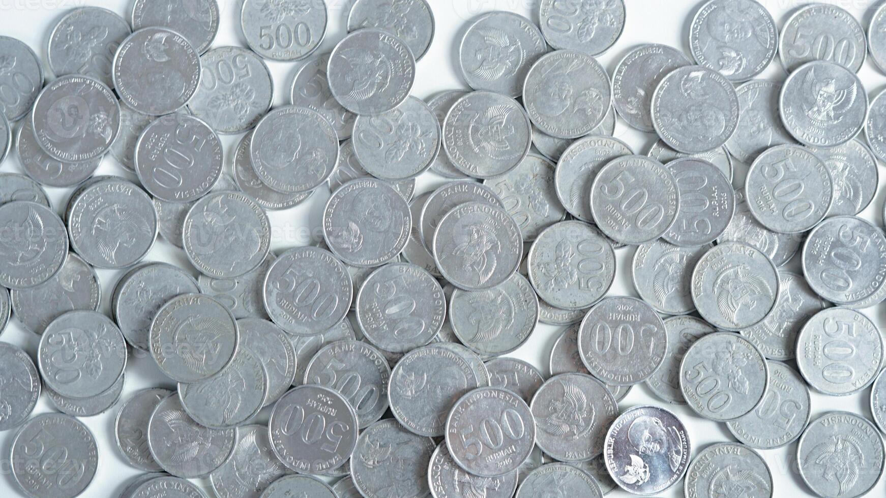 collection of Indonesian rupiah coins on a white background. photo