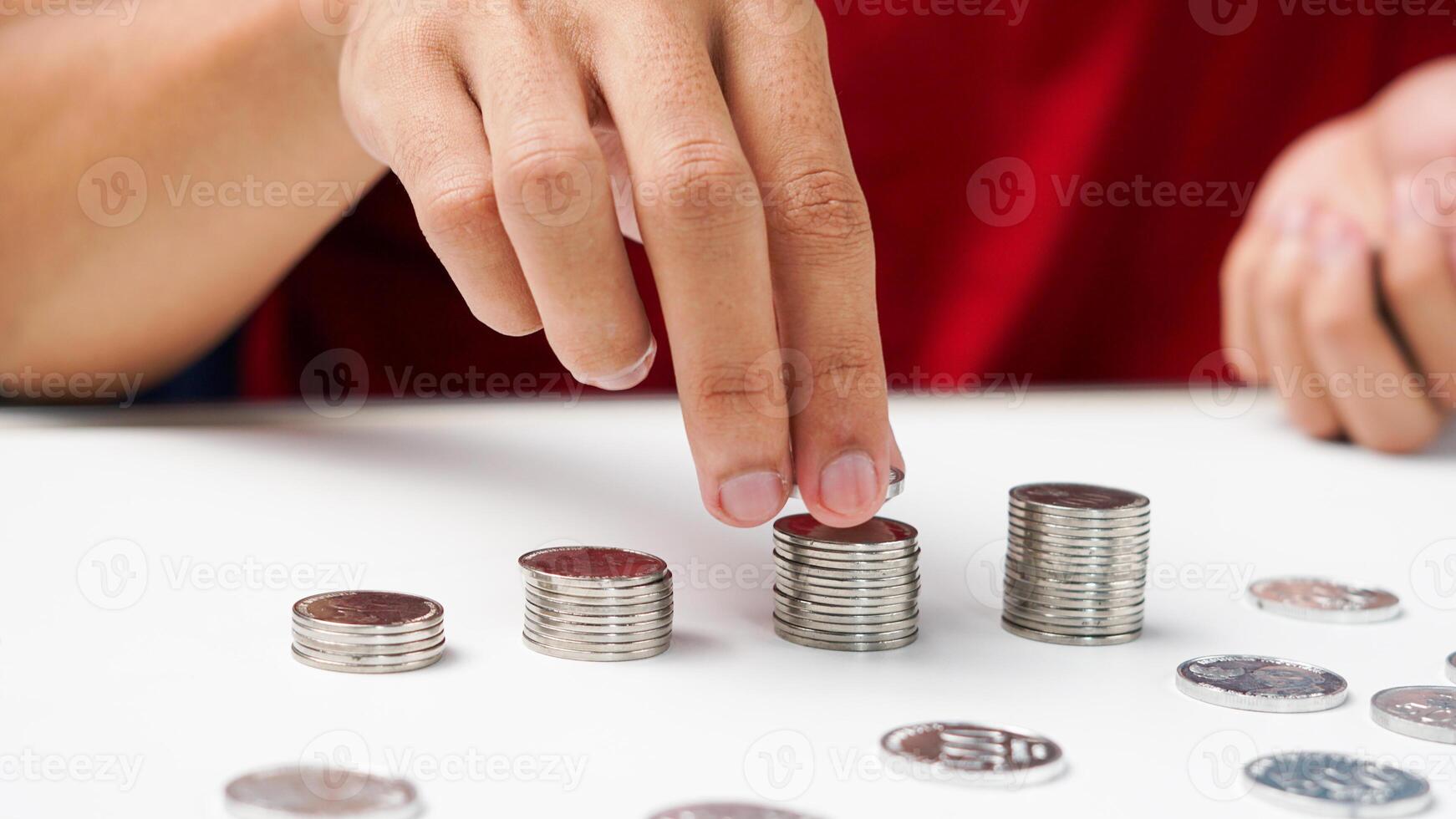 Man's hand puts money coins stack growing business. concept of saving coins photo