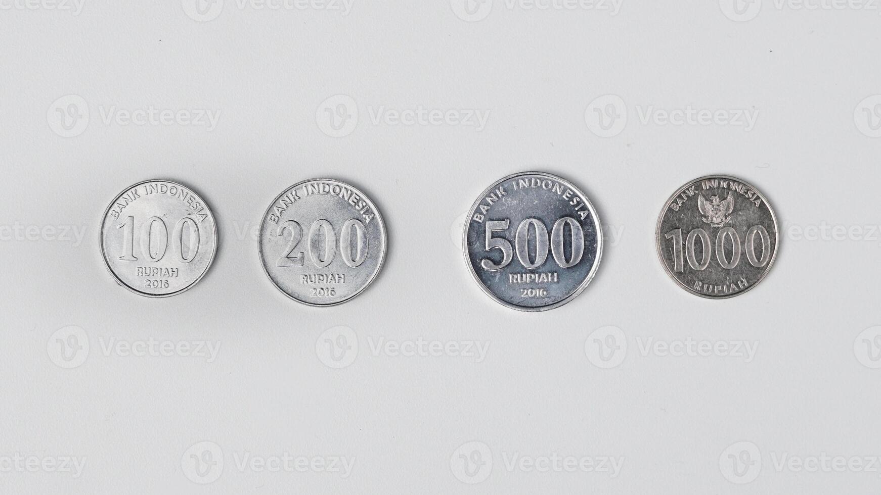 variants of 100, 200, 500 and 1,000 Indonesian rupiah coins photo