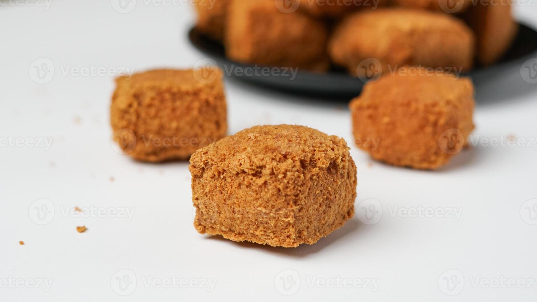 Fried tofu on a black plate in a white background photo