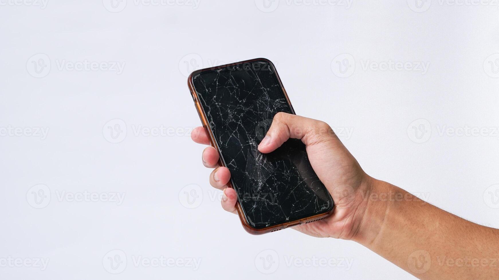 Man holding smartphone with broken touchscreen display on white background photo