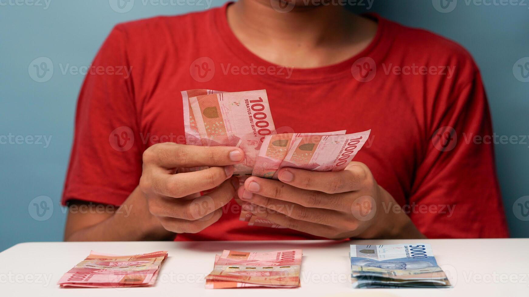 a man counts Indonesian rupiah money. financial management concept photo