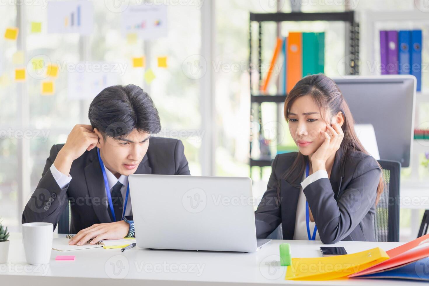 Business people discussing work and using laptop computers in modern offices, man and woman working and brainstorming in workplace photo