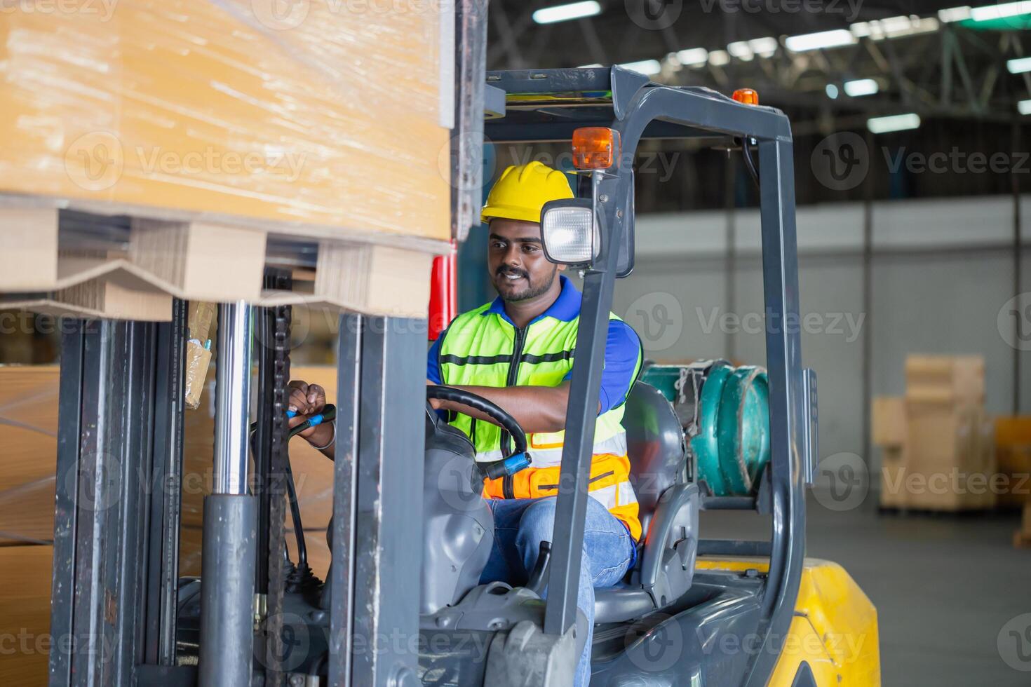 Worker driver at warehouse forklift loader works to containers box, worker man in warehouse with forklift photo