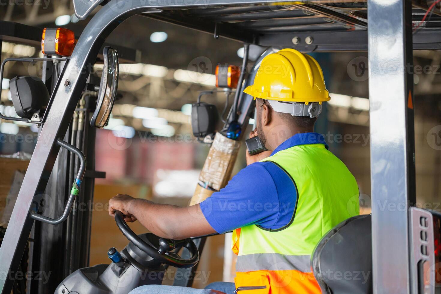 Worker driver at warehouse forklift loader works to containers box, worker man in warehouse with forklift photo