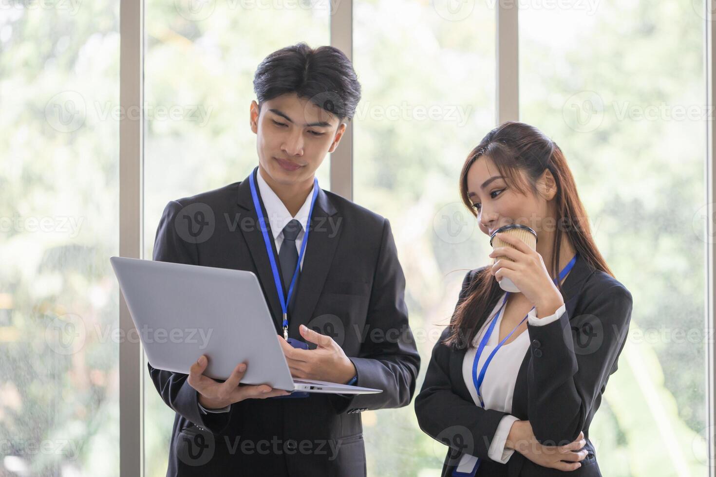 Young colleagues discussing and reading document projects in laptop, business team meetings in modern office photo