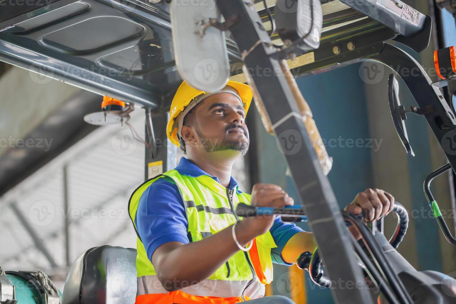 Worker driver at warehouse forklift loader works to containers box, worker man in warehouse with forklift photo