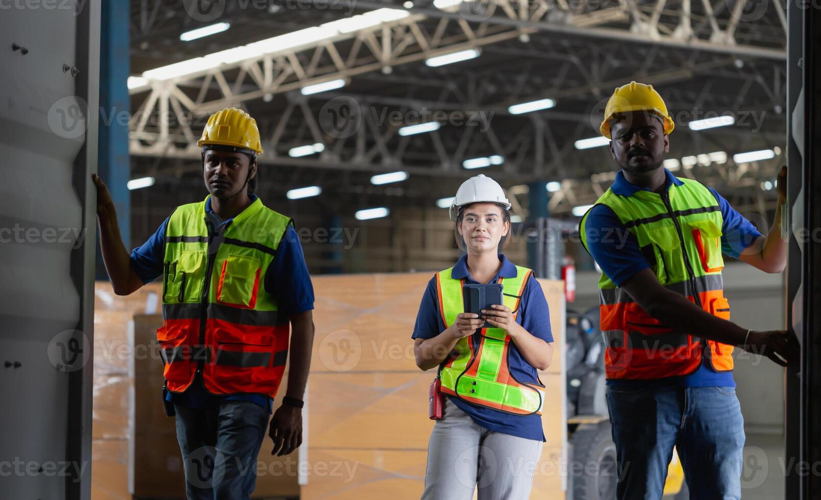 Foreman workers working in warehouse talking about job, Warehouse worker team checking containers boxes, Workers team taking inventory in factory warehouse photo