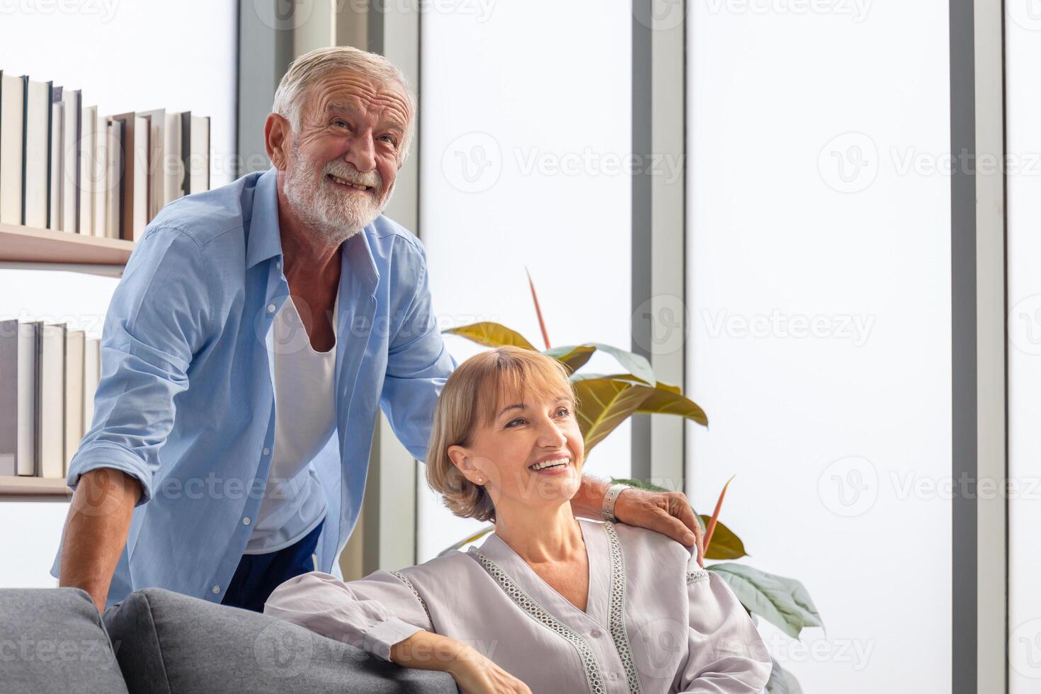 Senior couple in living room, Happy loving mature retired man taking care of wife, Family health care and support concepts photo