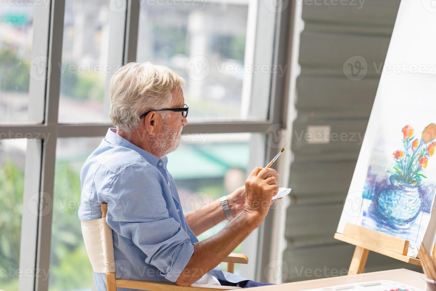 Senior man painting on canvas at home, Elderly man painting on a canvas, Happy retirement concepts photo