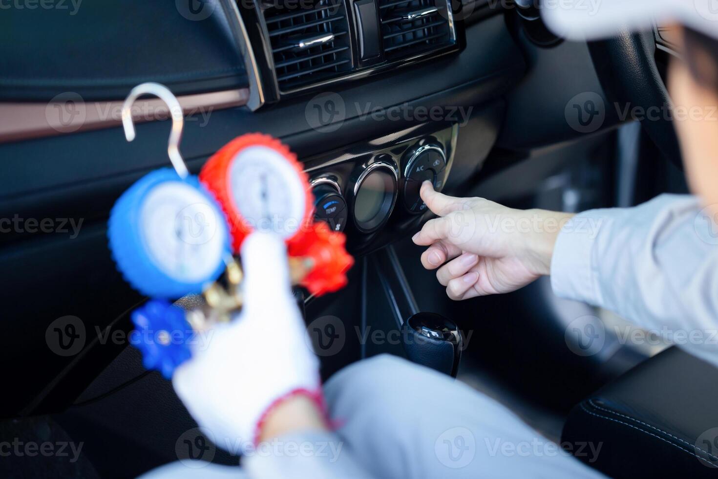 Car Air Conditioning Repair, Technician man checks car air conditioning system refrigerant recharge, Repairman with a monitor tool to check and fix car air conditioner system photo