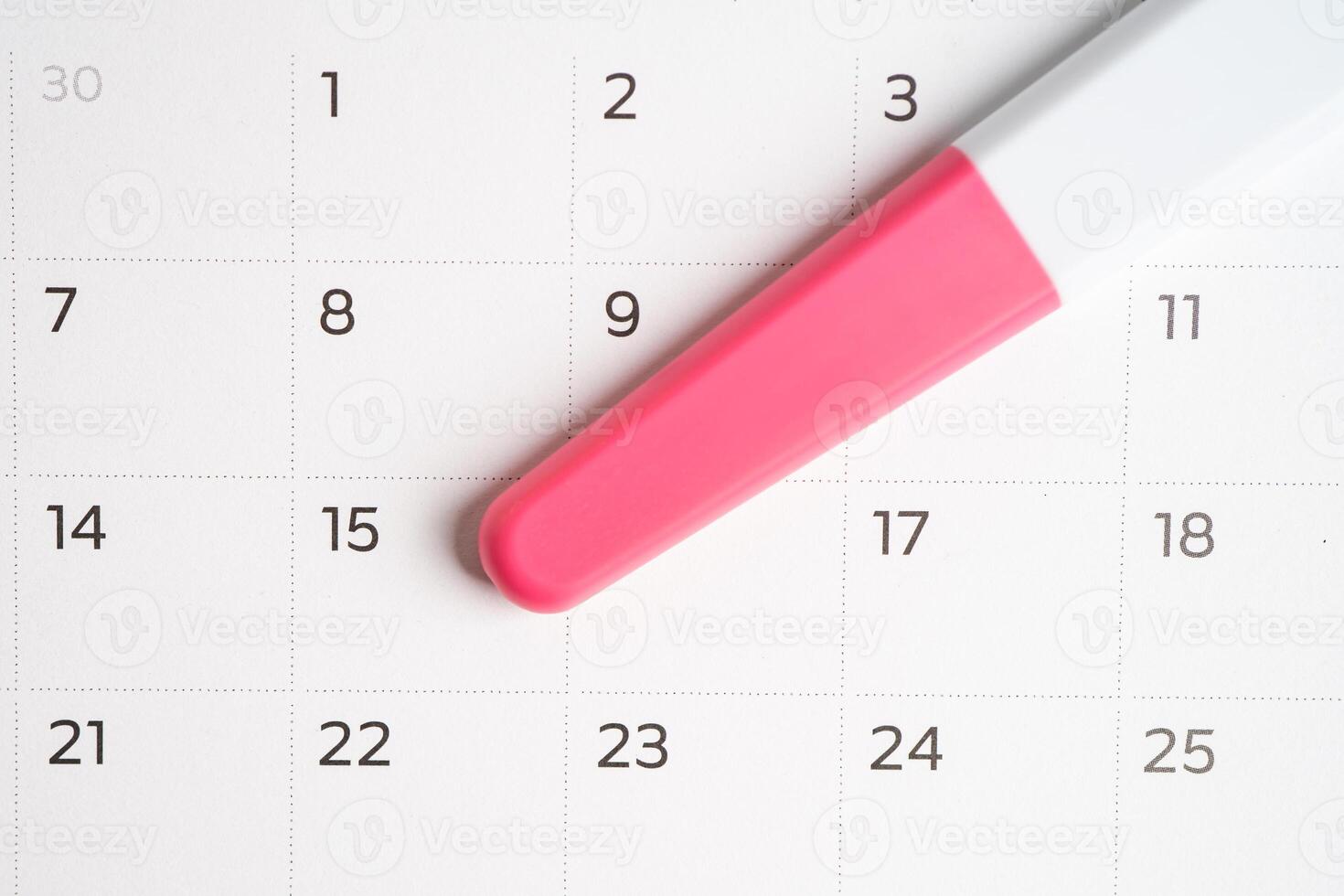 Pregnancy test for birth control on calendar, contraception health and medicine. photo