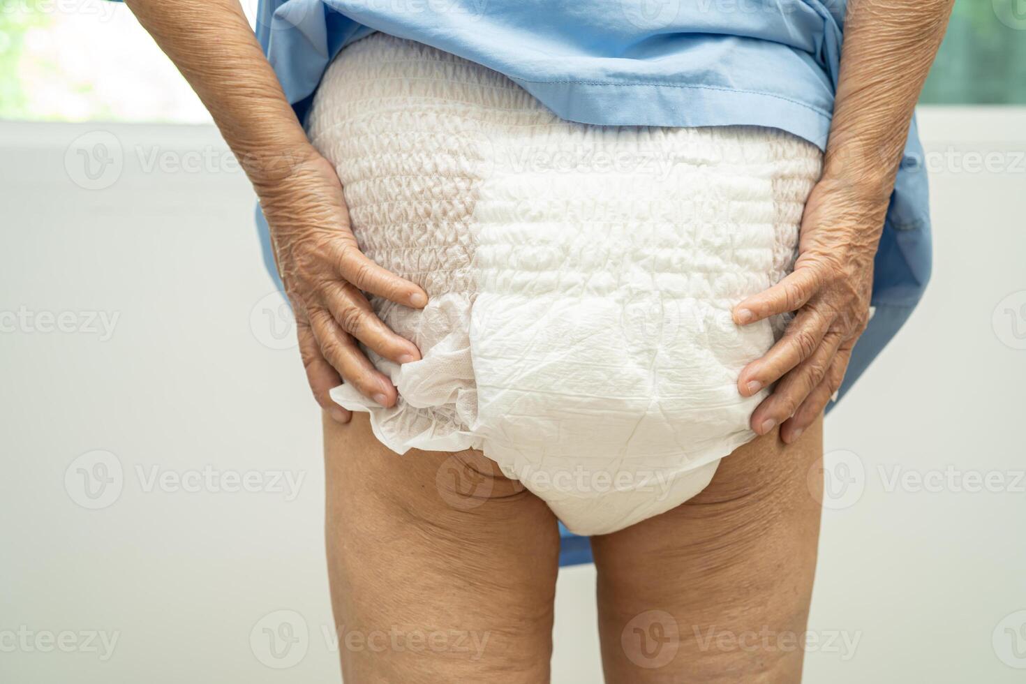 Asian senior woman patient wearing incontinence diaper in hospital, healthy strong medical concept. photo