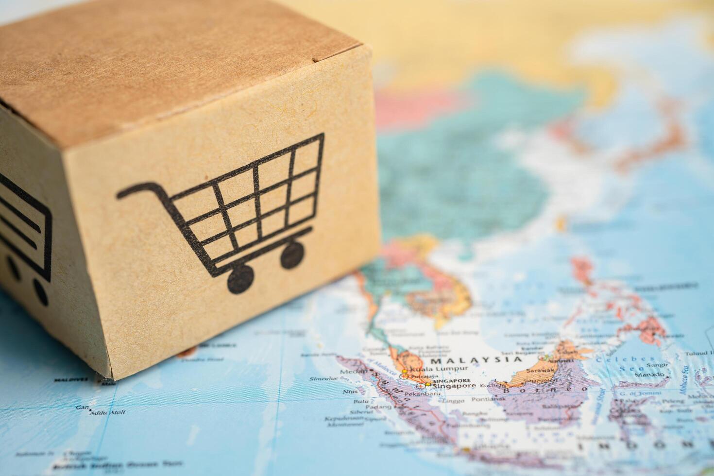 BANGKOK, THAILAND MARCH 1, 2023 Box with shopping online cart logo on Asia map, Import Export Shopping online or commerce finance delivery shipping, trade, supplier. photo