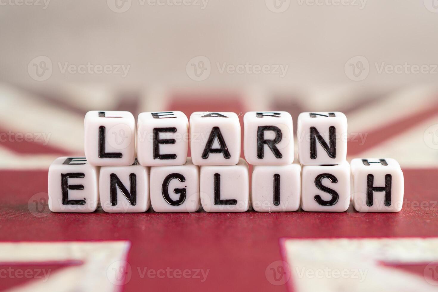 Word Learn English on book with United Kingdom flag, learning English language courses concept. photo