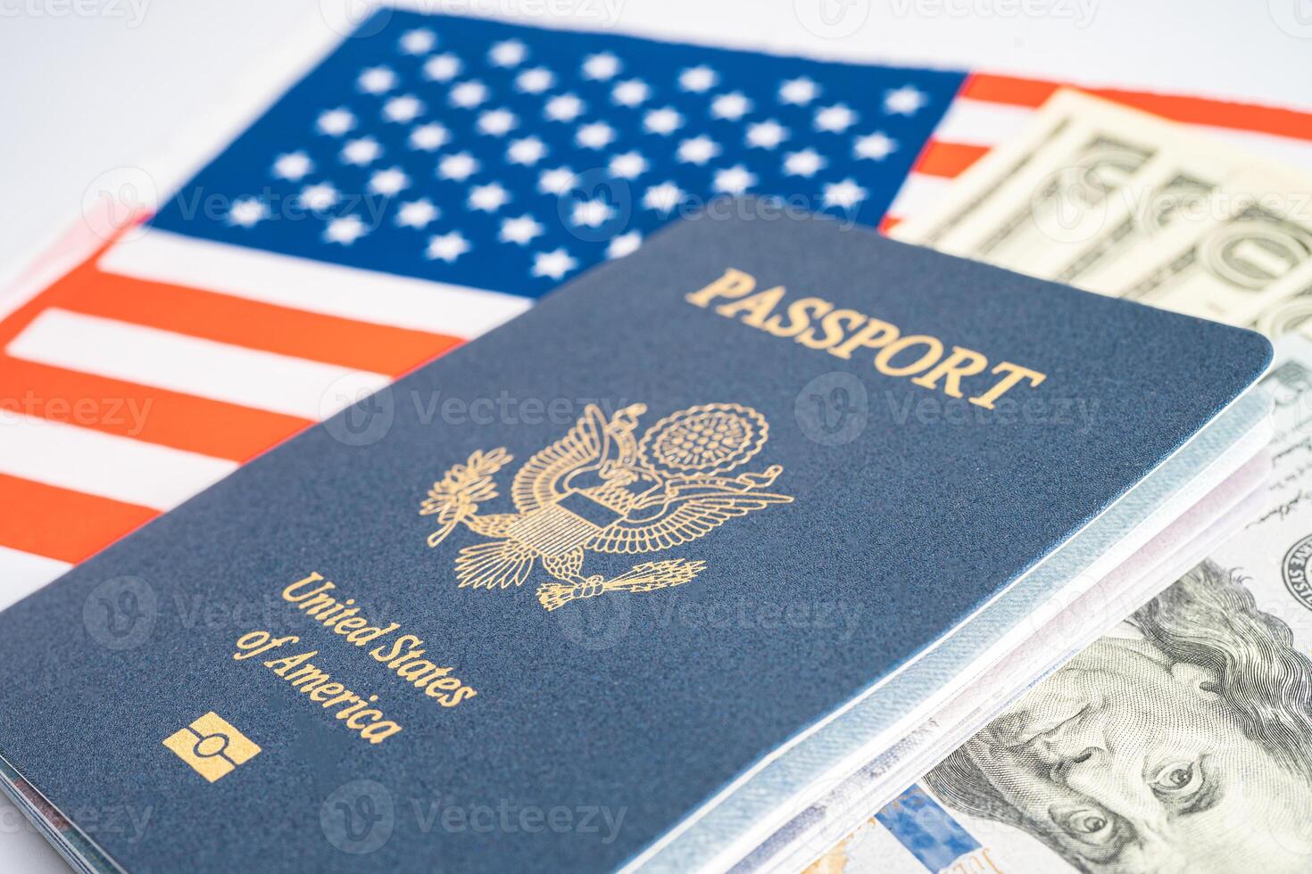 US passport issued to citizen and national of the United States of America to travel in most countries outside with USA flag and dollar money. photo