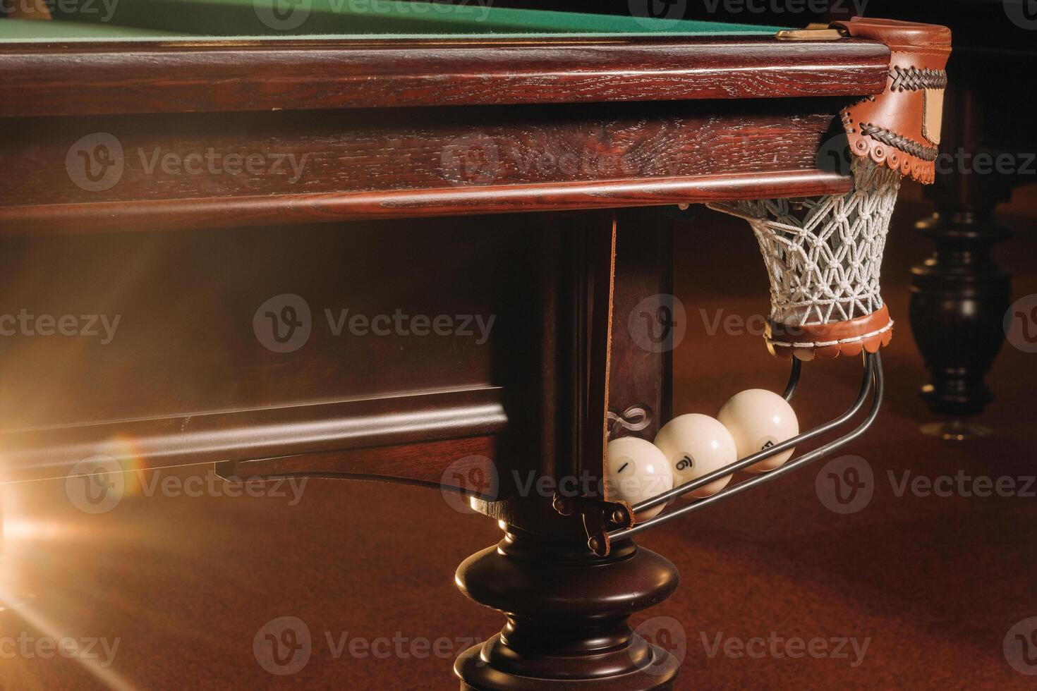 A pool table with balls that have already been played in the pool club.Playing billiards photo