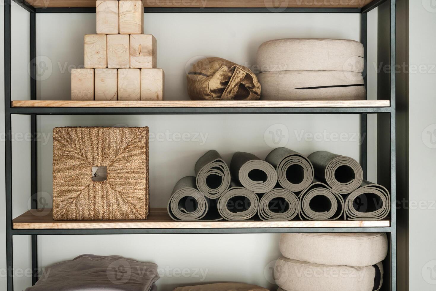 Sports equipment for yoga classes is on the shelf in the gym photo