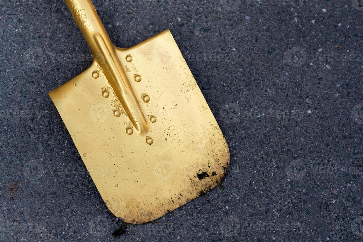 A golden shovel is lying on the asphalt.Opening Ceremony photo