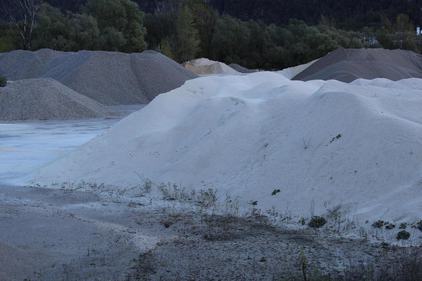 Heavy machinery for crushing and collecting stone, limestone, sand and gravel, materials for asphalt and road paving producers, construction. Road asphalt recycling and storage plants. photo