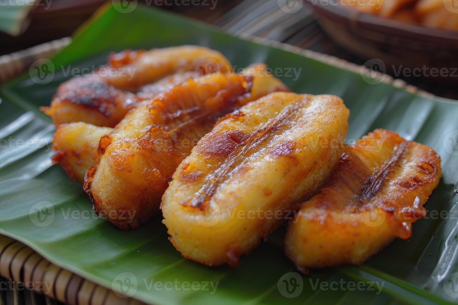 Fried banana on banana leaf plate. Tropical dessert. photo