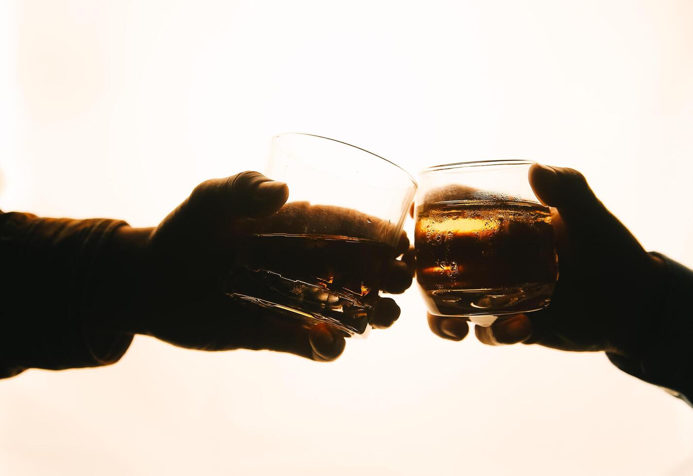 Whiskey splashing out of glass, isolated on white background photo