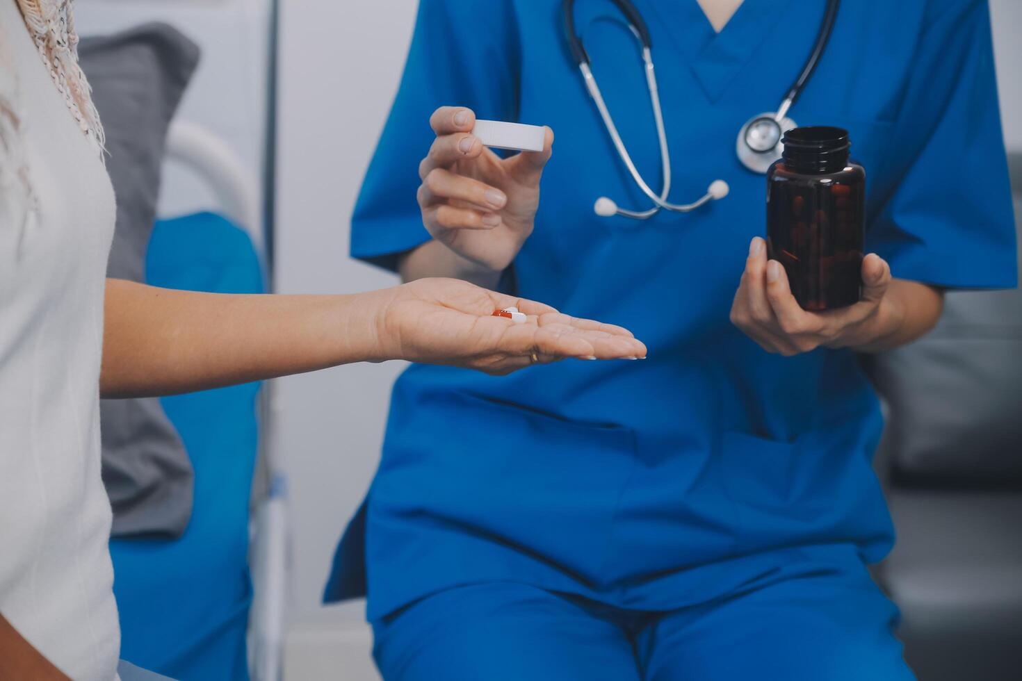 Asian woman nurse holding a medicine bottle and telling information to Asian senior woman before administering medication. Caregiver visit at home. Home health care and nursing home concept. photo