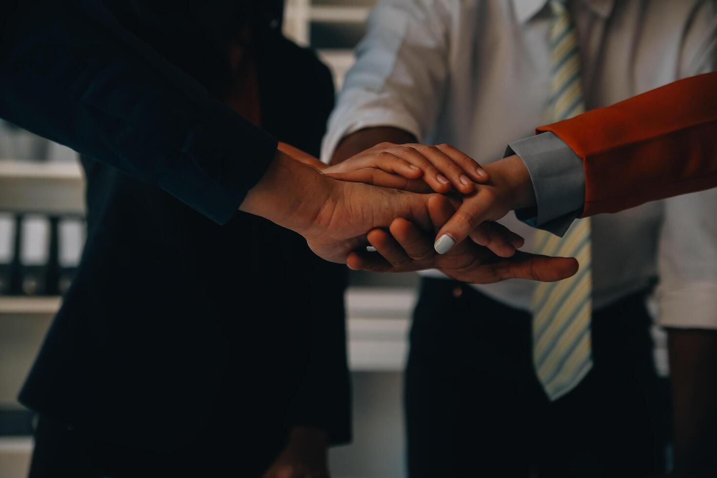 Large business team showing unity with their hands together photo