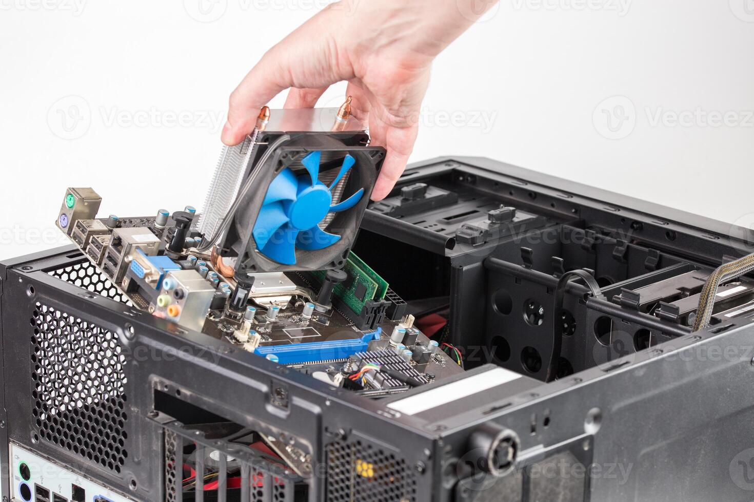 hand putting in or removing pc internals while maintenance personal computer hardware with selective focus photo