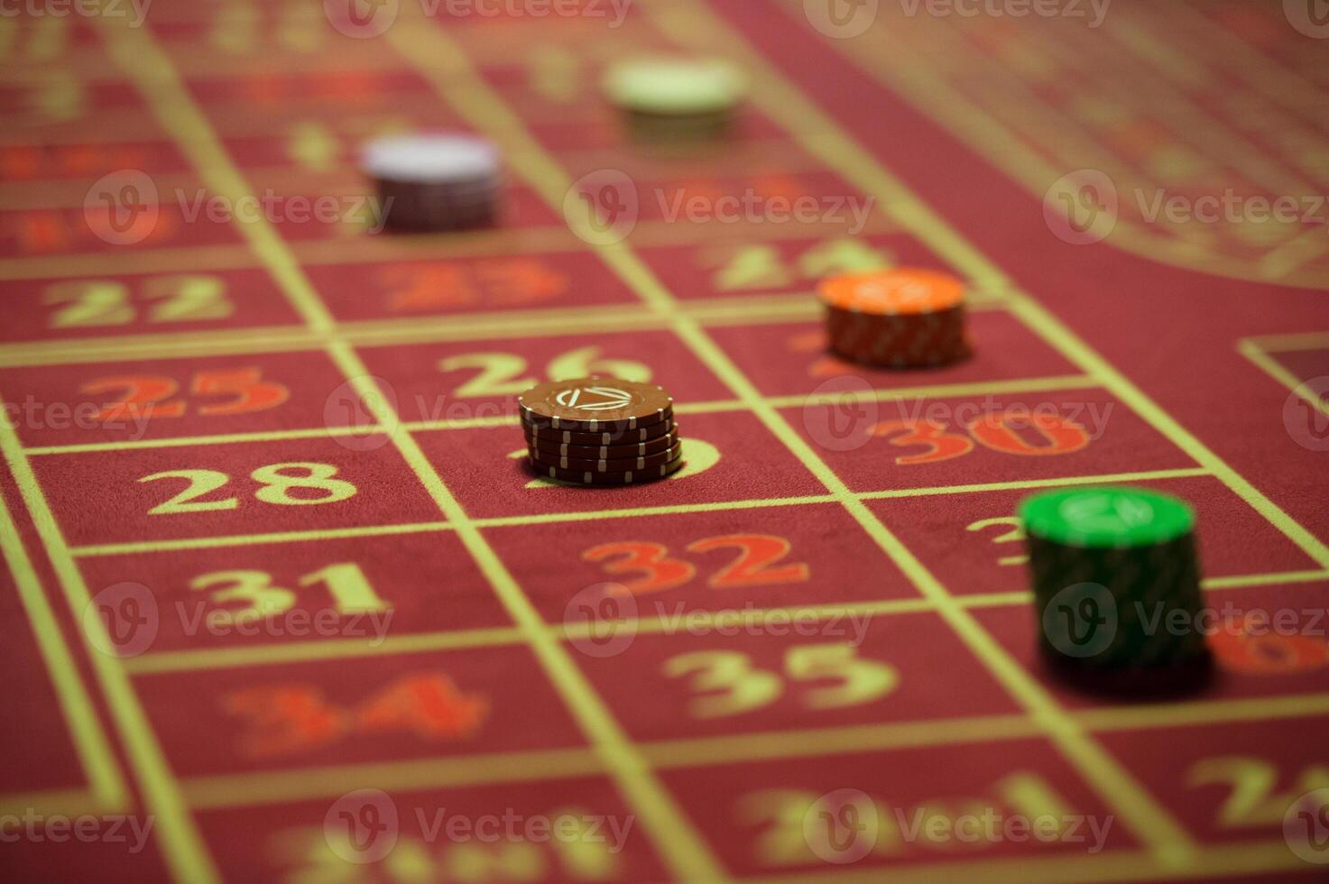 close-up of casino chips on the red table photo