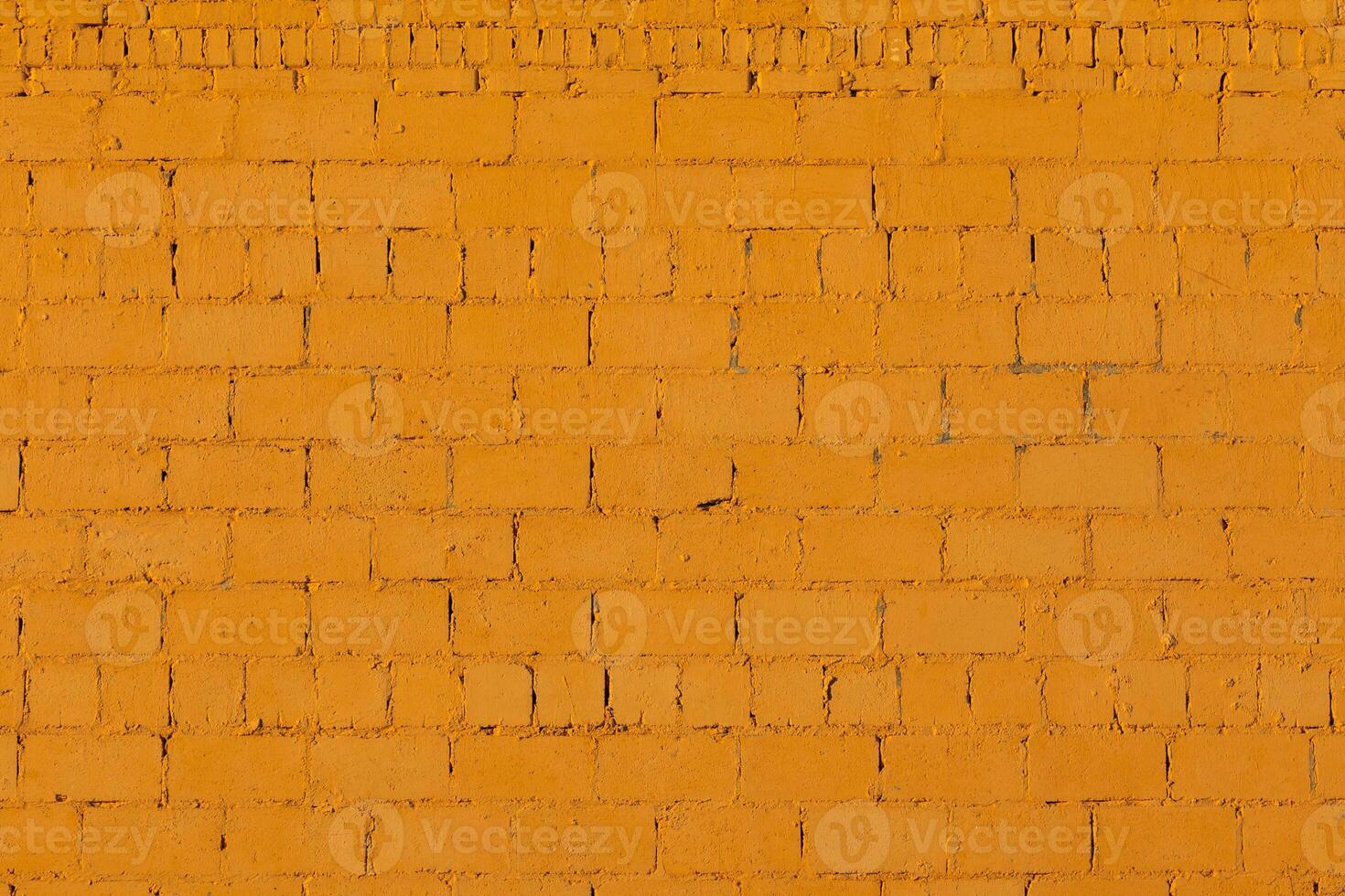 Textura de pared exterior de ladrillo áspero de yeso naranja foto