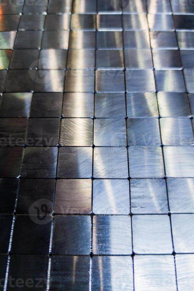 shiny steel machined blocks pavement surface background - close-up with selective focus and blur photo