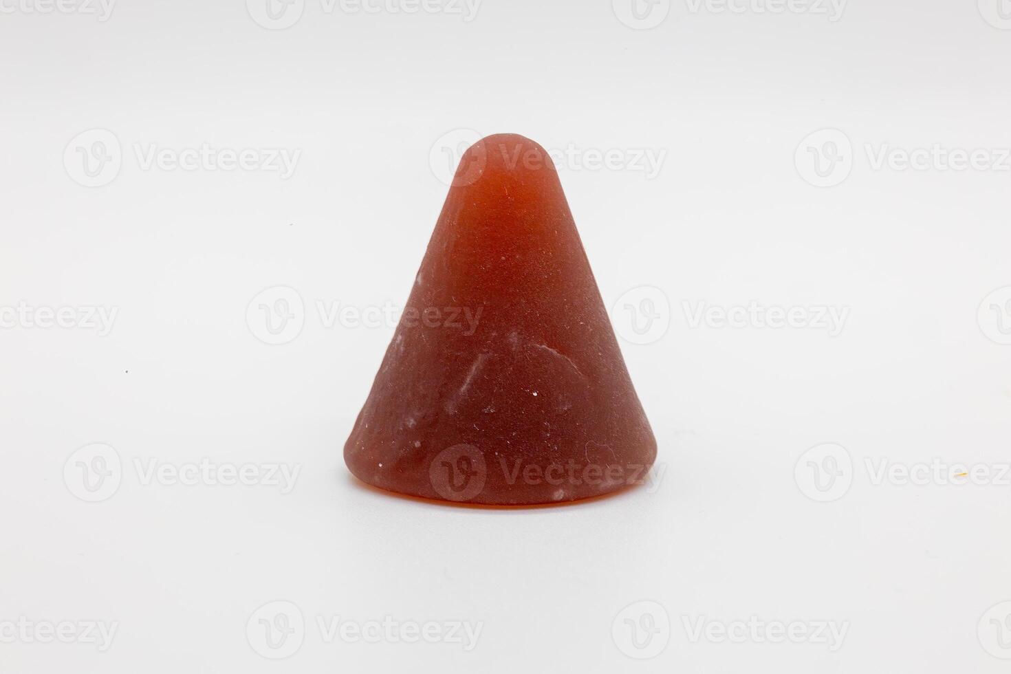 Closeup of cuberdon, a cone-shaped Belgian candy on a white background photo