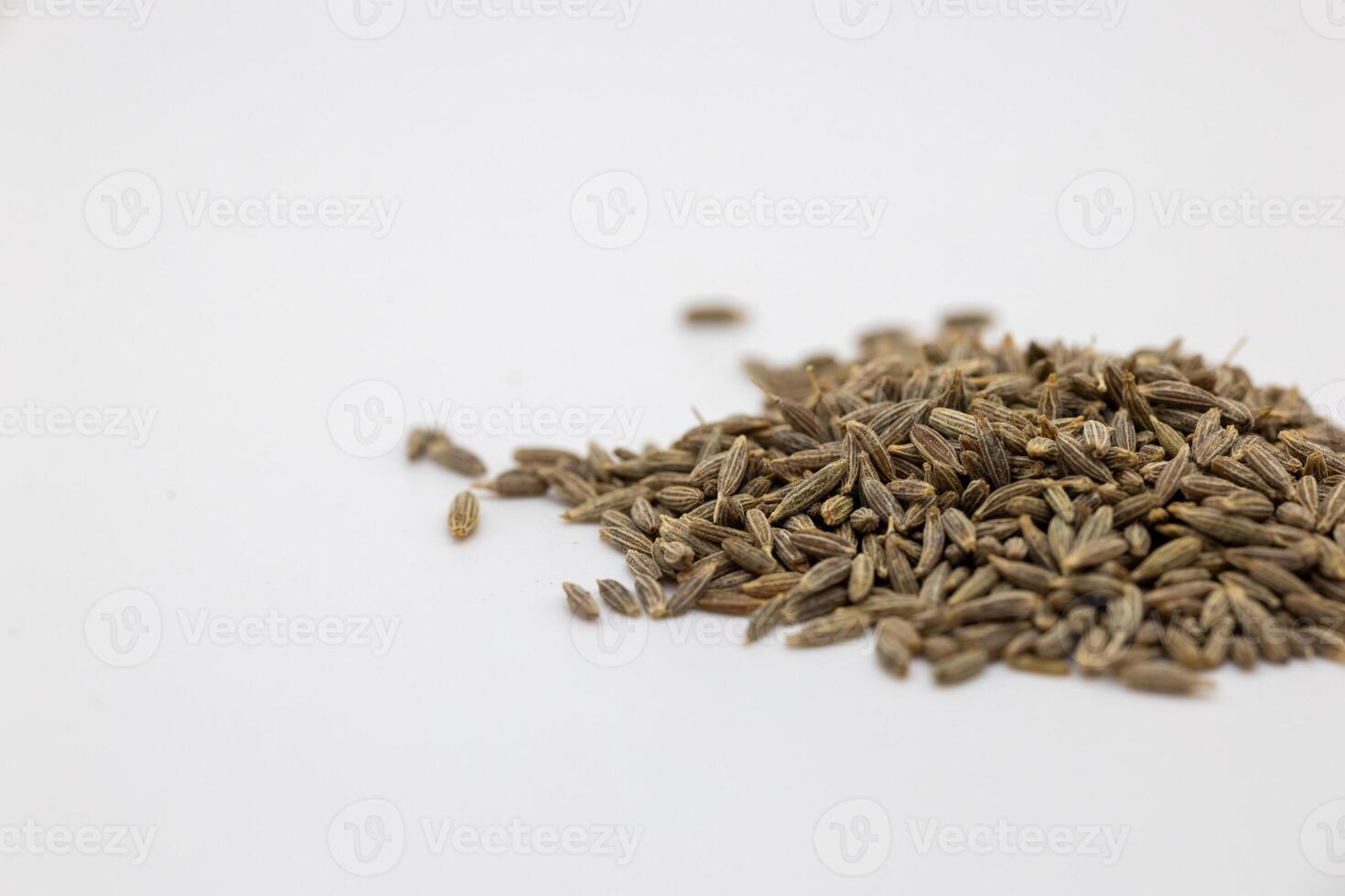 a pile of Cumin seed that is sitting on a white surface photo