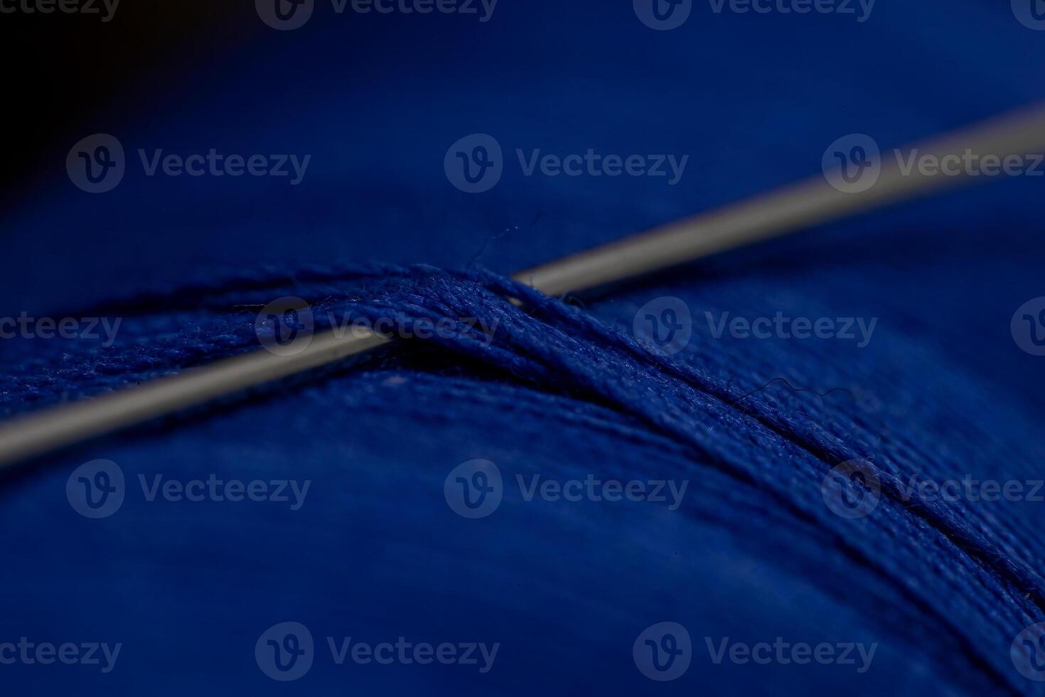 Detailed close-up shot of a needle in a blue thre photo