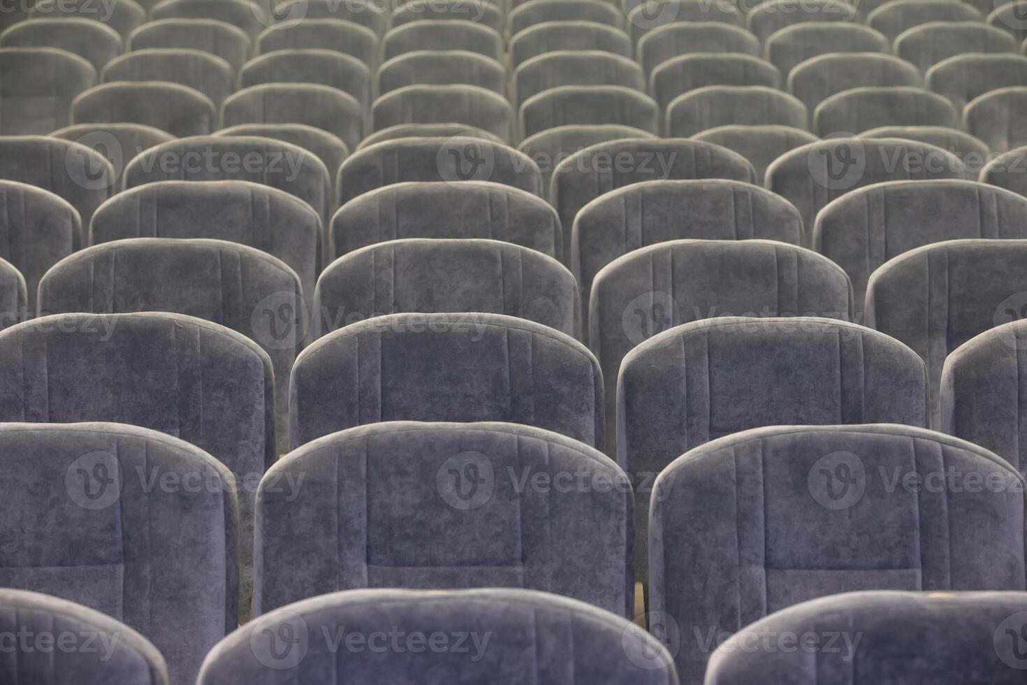 Background gray chairs are empty in the auditorium or concert hall. photo