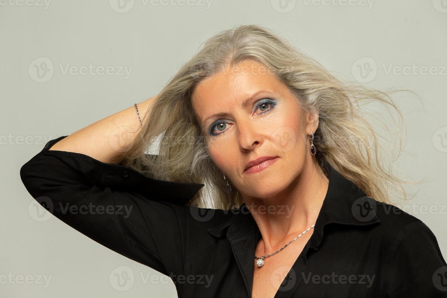 Beautiful grey-haired 50s woman looking at camera isolated on white. Mature old lady close up portrait. Healthy facial skin care, middle aged skin care cosmetics, cosmetology concept photo