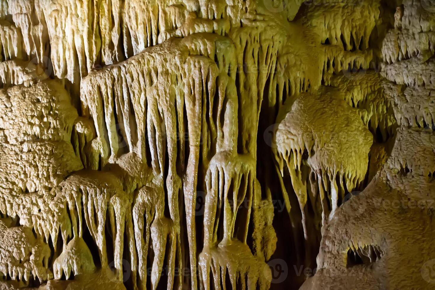 The cave is karst, amazing view of stalactites and stalagnites illuminated by bright light, a beautiful natural attraction in a tourist place. photo