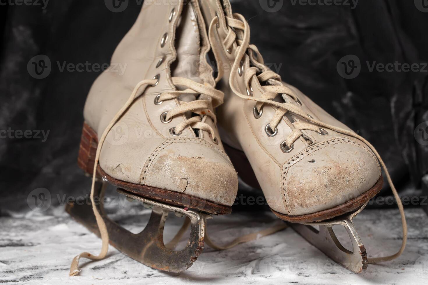 Vintage old skates on a snowy background. photo