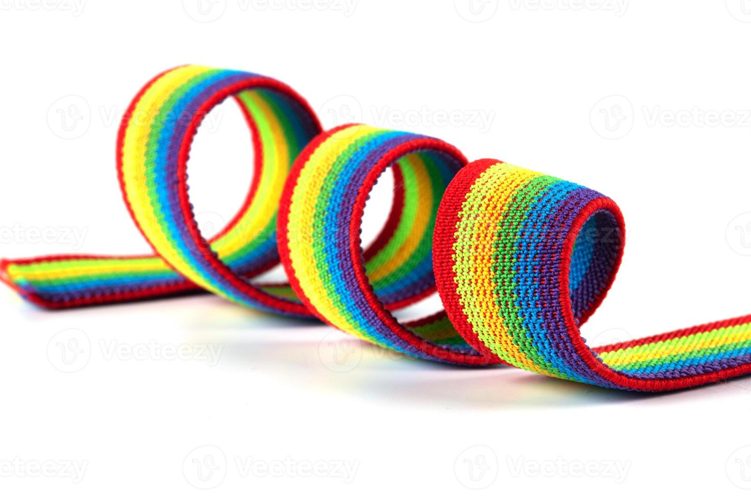 Colorful rainbow ribbon closeup isolated on white background. Colorful LGBT design. Curly, fluttering ribbon. photo